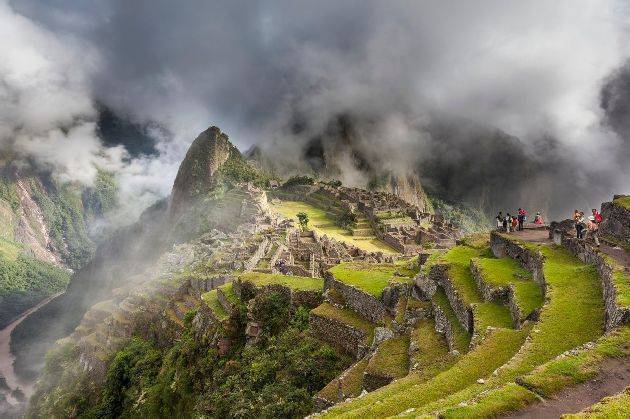 Morning fog and clouds reveal Machu Picchu, the ancient "lost city of the Incas", 1400 CA, 2400 meters. Discovered by Hiram Bingham in 1911. One of Peru's top tourist destinations. Urubamba river in the distance., Image: 177456934, License: Rights-managed, Restrictions: , Model Release: no, Credit line: Profimedia, Corbis